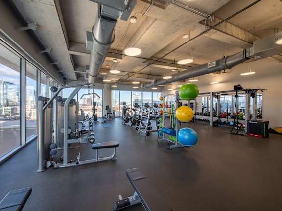 A gym with a view of the city outside the windows.