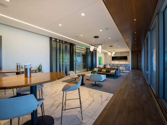 A modern dining area with a long table and chairs.
