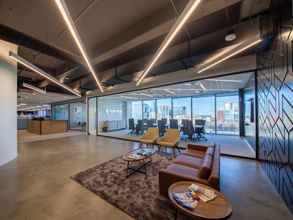 A modern office space with a large window overlooking the city.