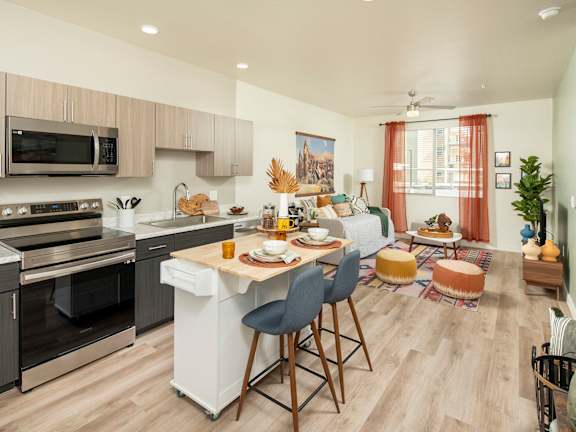 A modern kitchen with a black countertop and white cabinets.