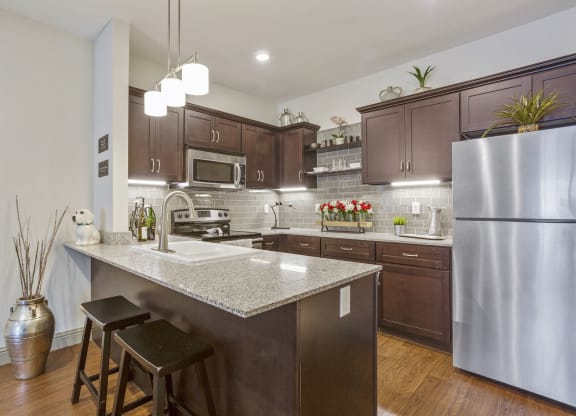 a kitchen with stainless steel appliances and granite counter tops
