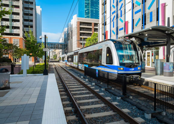 a blue and white train pulling into a train station
