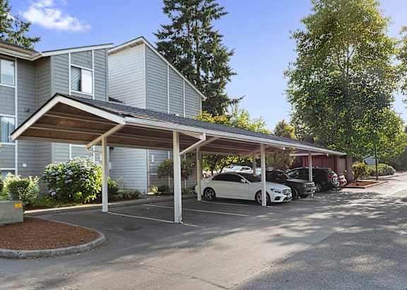 A carport with a white car parked under it.
