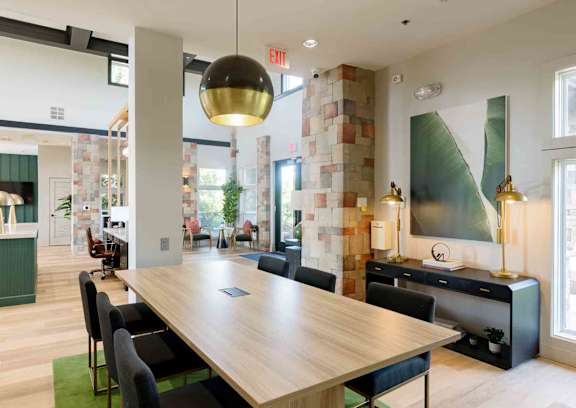A conference room with a long table and chairs.