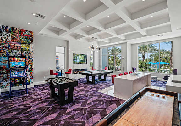 A room with a pool table and a shelving unit with comic books.