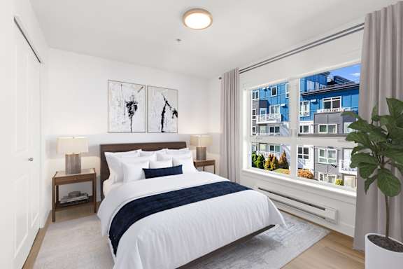 a bedroom with a bed and a ceiling fan