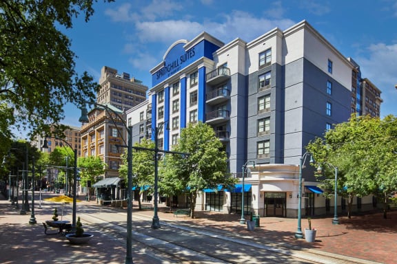 a rendering of a blue and white building on a city street