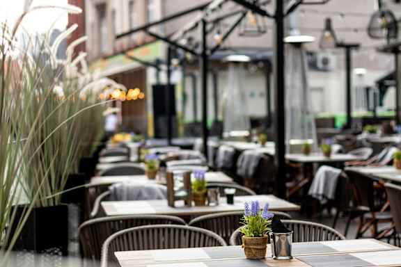 a restaurant with tables and chairs and plants