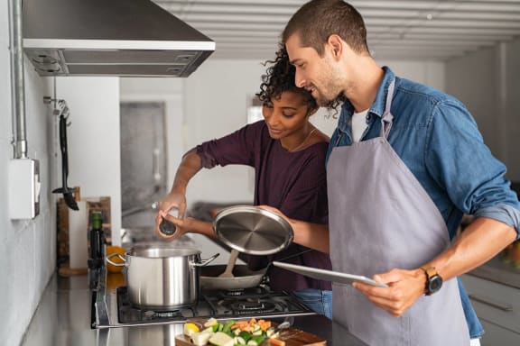 a couple cooking in the kitchen at Villa Springs, Houston, Texas