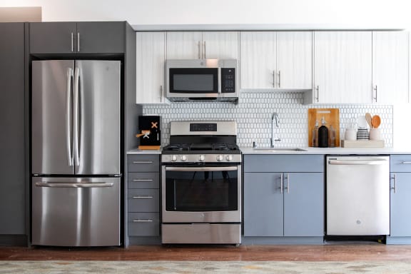a kitchen with stainless steel appliances and white cabinets