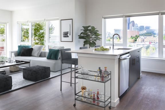 a kitchen and living room in an apartment with a large window