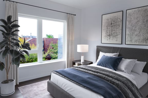 a bedroom with a bed and a large window