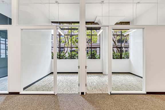 A white door with a glass window is open.