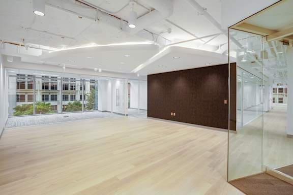 A room with a brown wall and wooden floor.