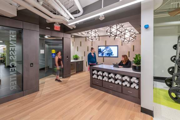A reception area with a woman sitting behind the desk.