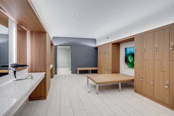 A modern room with wooden cabinets and a bench.