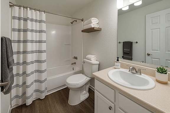 A white toilet sits next to a sink in a small bathroom.