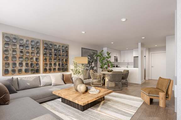 A modern living room with a grey sofa, a wooden coffee table, and a large artwork on the wall.