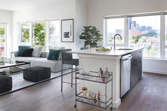 a kitchen and living room in an apartment with a large window