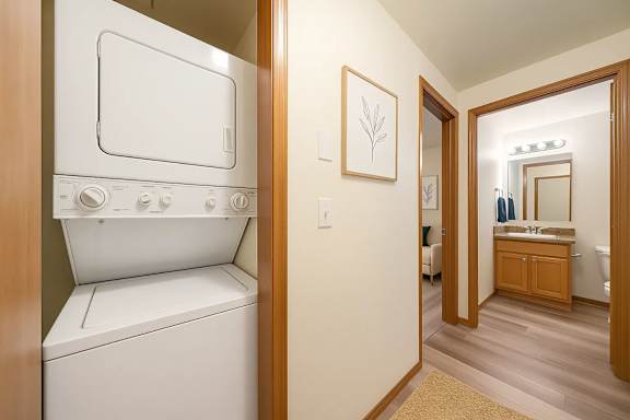 A white washing machine in a small laundry room.