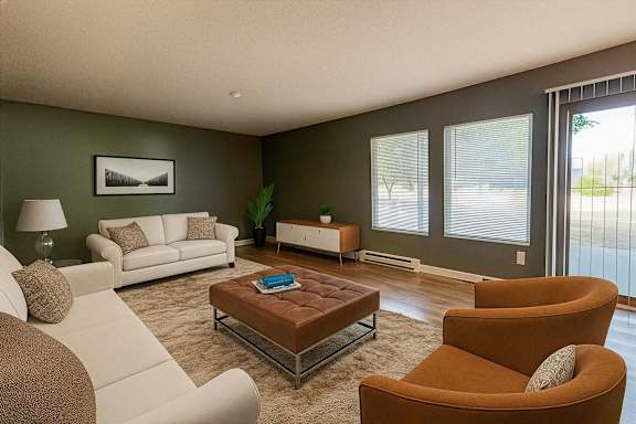 A living room with a white couch, a brown armchair, and a coffee table.