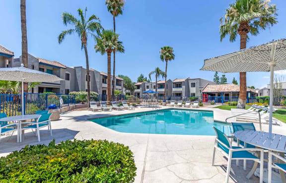 Swimming Pool Area With Shaded Chairs at Agave Apartments, Tucson, Arizona