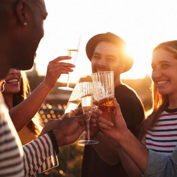 a group of people celebrating with wine glasses