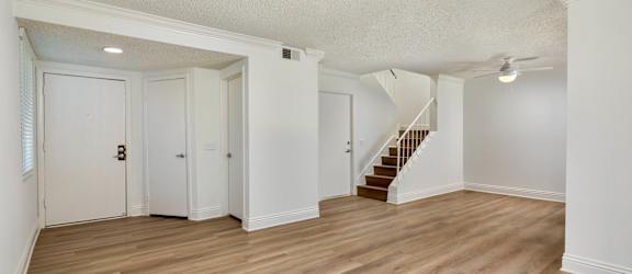 A room with wooden floors and white walls.