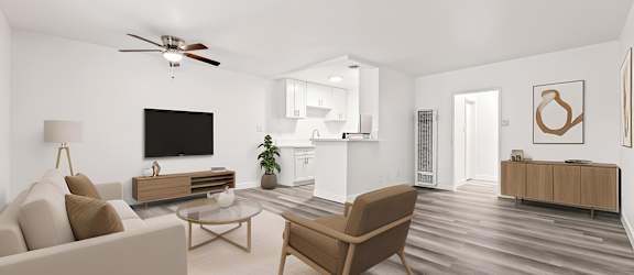 A living room with a brown chair, a white couch, and a wooden coffee table.