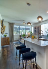 an open kitchen with an island and stools