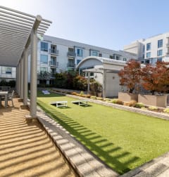 a backyard with a lawn and a table and chairs at Strata at Mission Bay, San Francisco, CA, 94158