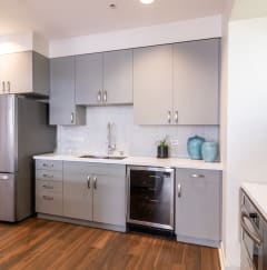 a renovated kitchen with stainless steel appliances and white cabinets at Strata at Mission Bay, California, 94158