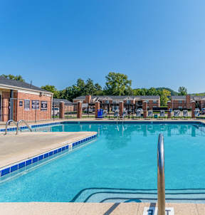 our apartments offer a swimming pool with tables and chairs at Brightwaters Apartments, Little Rock, Arkansas