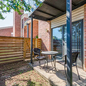 a patio with a table and chairs on a porch at Brightwaters Apartments, Little Rock, Arkansas