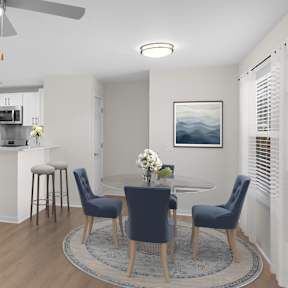 A modern kitchen with a dining table set for four.