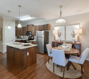 A kitchen with a dining table and chairs. at Hall Creek Apartment Homes, Arlington, Tennessee