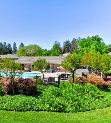 building exterior and pool at The Seasons Apartments in San Ramon, CA