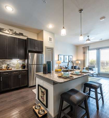 Cromwell at Plum Creek Kitchen with Island and View into Living Room