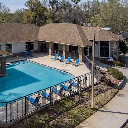 an aerial view of a swimming pool and a house with a pool at Tivoli Apartments, Gainesville, Florida, 32608