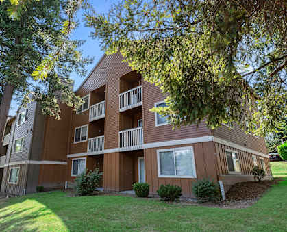 A large apartment building with a balcony on the second floor.
