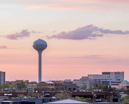 A cityscape with a tall tower in the center and the word "Edina" on it.
