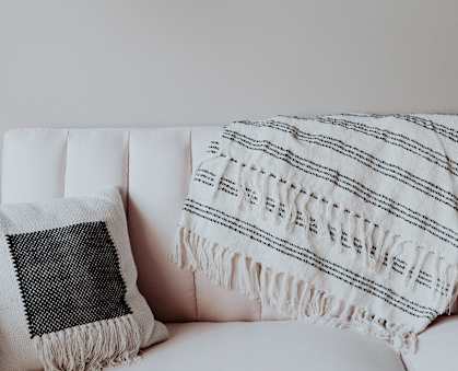 a white couch with a black and white throw pillow
