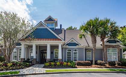 a house with palm trees in front of it
