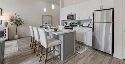 A modern kitchen with a dining table and chairs. at 200 City View, Provo, UT, 84601