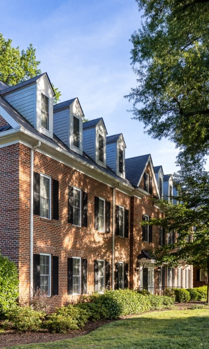 a brick house with a sidewalk in front of it