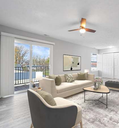 A living room with a white couch and a grey chair.