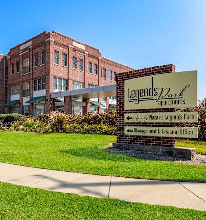 a large brick building with a sign in front of it