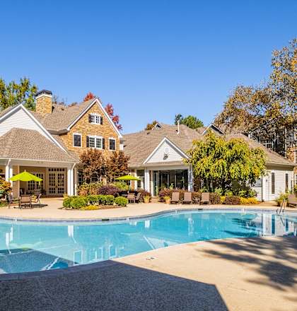 a swimming pool with a house in the background