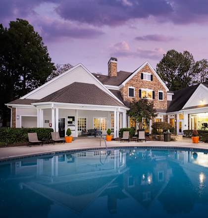 a large swimming pool in front of a house