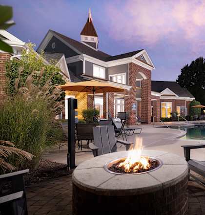 a backyard with a fire pit and a swimming pool